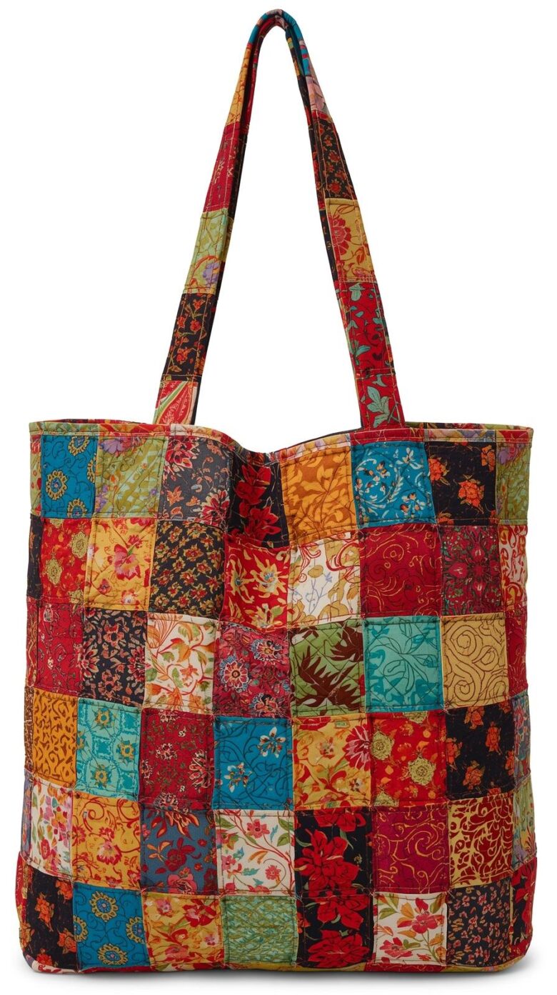 eye catching patchwork tote bag made from 4 inch fabric squares sewn in a grid featuring a mix of colorful patterns and solid fabrics